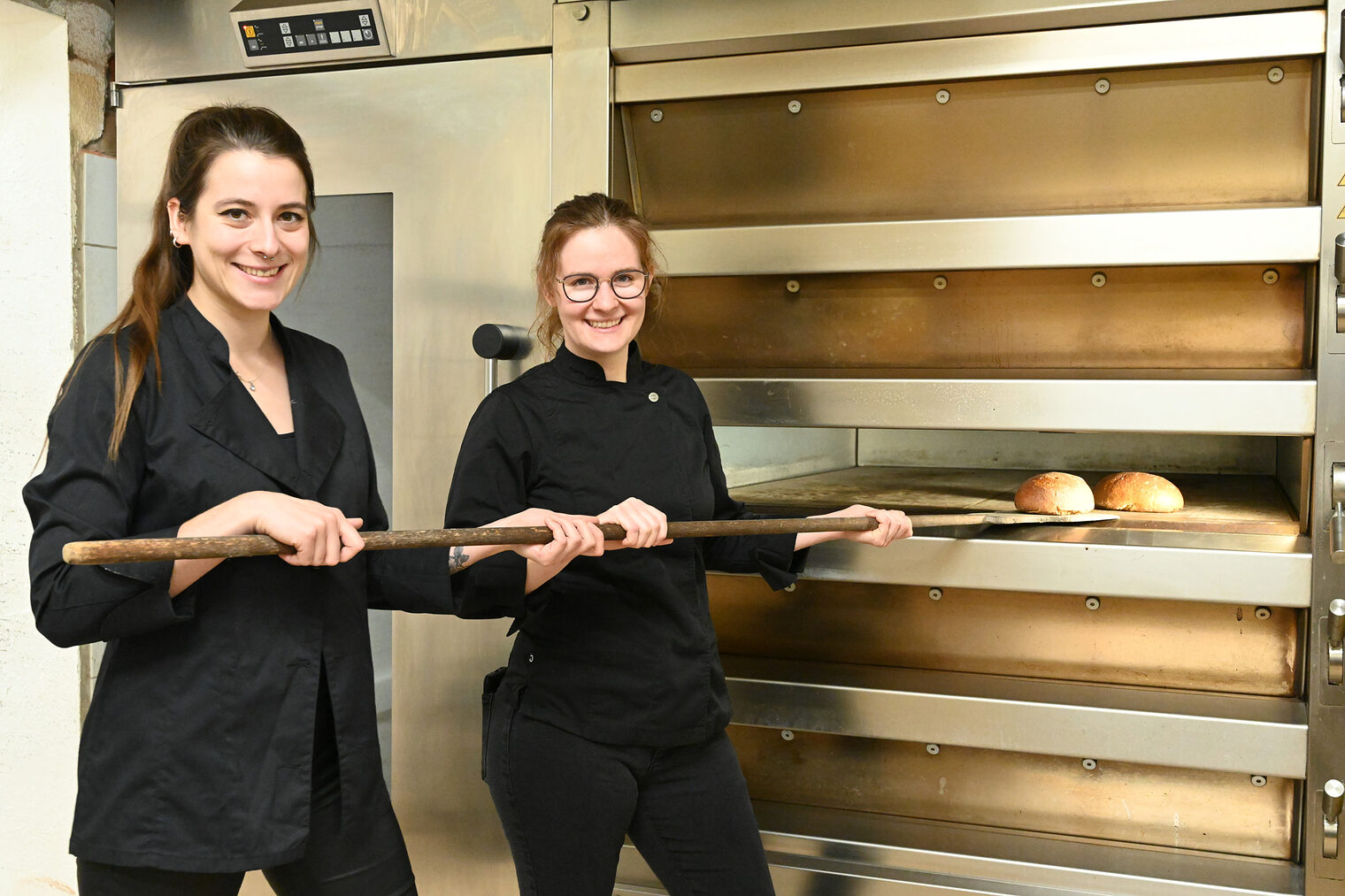 Deutsche Meisterinnen Bäckerhandwerk Bäckerinnen am Backofen, schieben Brote hinein
