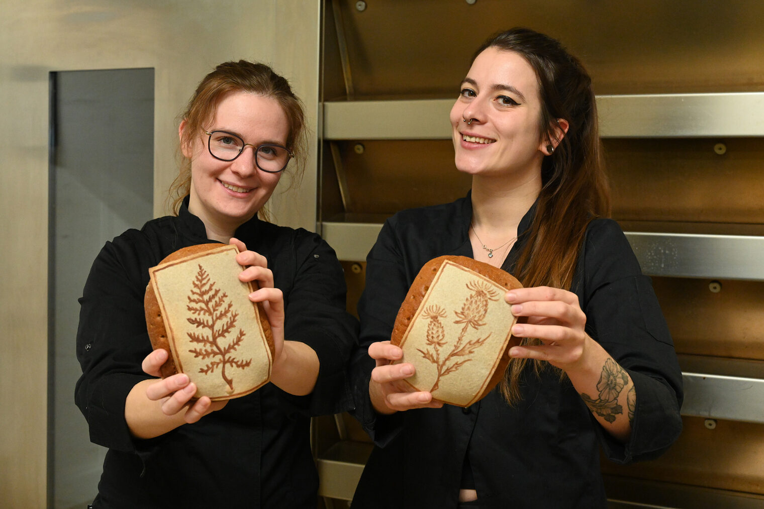 Deutsche Meisterinnen Bäckerhandwerk Bäckerinnen halten beide ein Brot in die Kamera